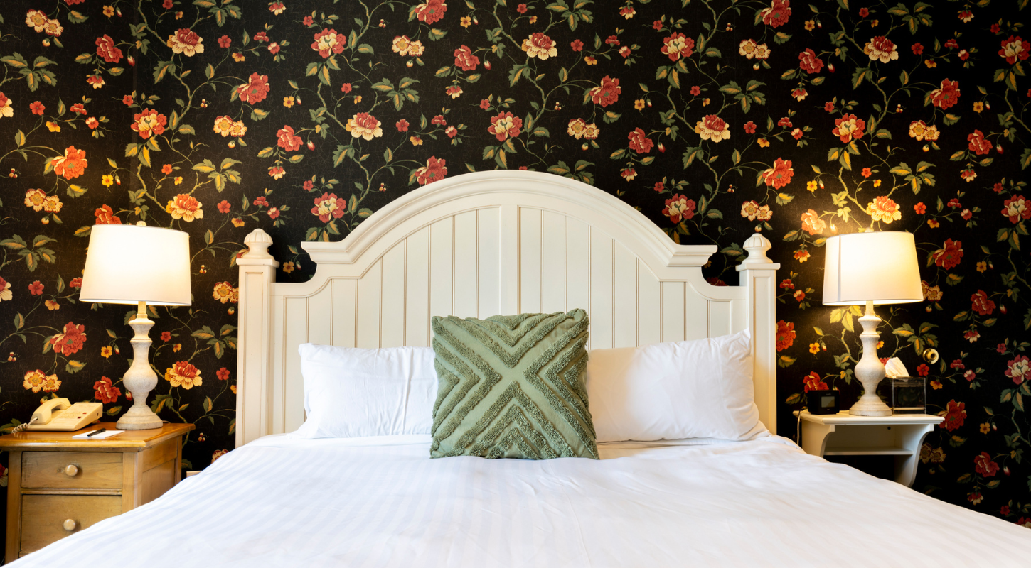 Plush bedding with floral accent wall