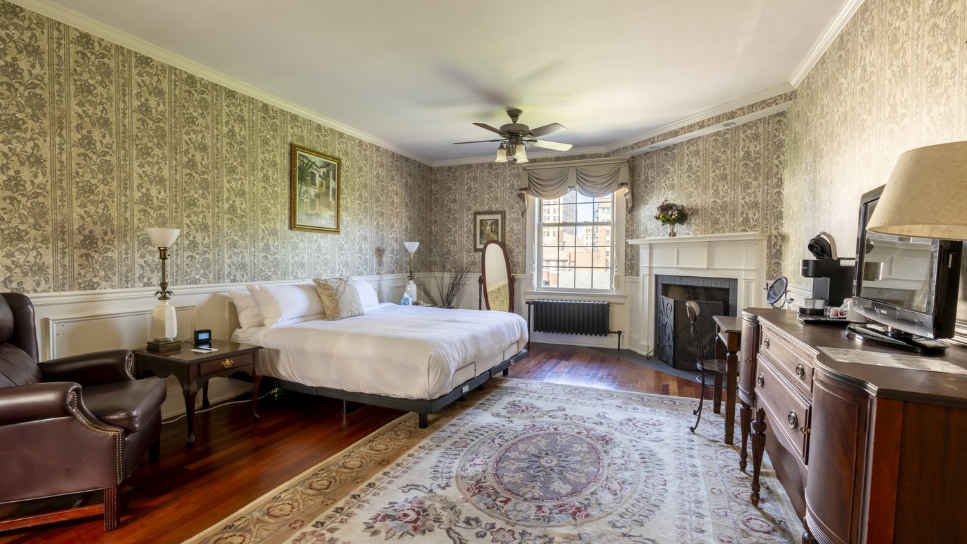 Luxury Room 401 showing fireplace and view of bed